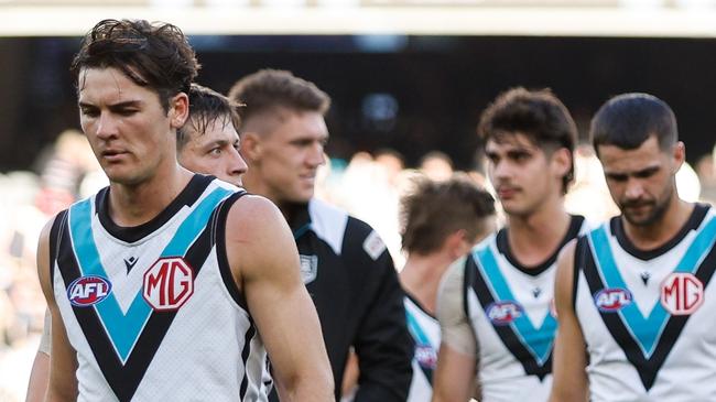 MELBOURNE, AUSTRALIA - APRIL 20: Port Adelaide leave the field looking dejected after a loss during the 2024 AFL Round 06 match between the Collingwood Magpies and the Port Adelaide Power at the Melbourne Cricket Ground on April 20, 2024 in Melbourne, Australia. (Photo by Dylan Burns/AFL Photos via Getty Images)