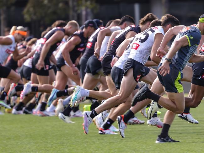 AFL. Collingwood pre-season training at AIA Vitality Centre. Umpires limber up with players. Picture: Ian Currie