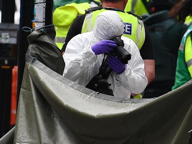 Crime scene officers gather evidence at the site of the stabbings. Picture: Getty