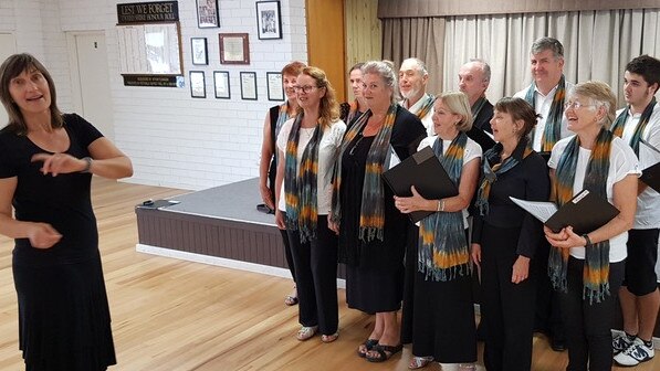 Leading members of The Choir Pott in reherasal ahead of their debut on the weekend is musical difrector Helen Bub-Connor. Photo: SUE BECKINSALE