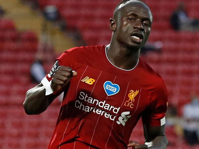 Liverpool's Senegalese striker Sadio Mane celebrates scoring his team's fourth goal during the English Premier League football match between Liverpool and Crystal Palace at Anfield in Liverpool, north west England on June 24, 2020. (Photo by PHIL NOBLE / POOL / AFP) / RESTRICTED TO EDITORIAL USE. No use with unauthorized audio, video, data, fixture lists, club/league logos or 'live' services. Online in-match use limited to 120 images. An additional 40 images may be used in extra time. No video emulation. Social media in-match use limited to 120 images. An additional 40 images may be used in extra time. No use in betting publications, games or single club/league/player publications. /