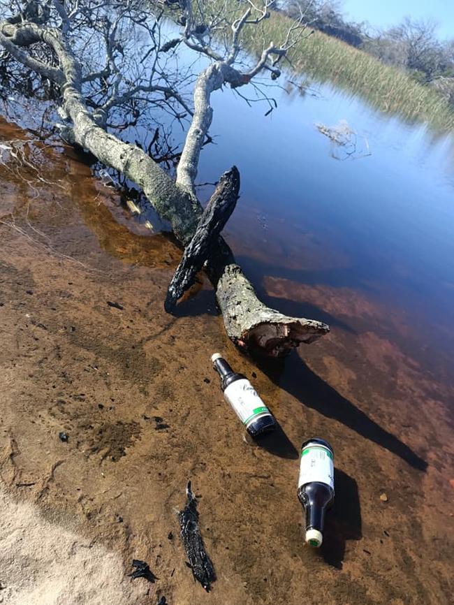 Empty alcohol containers were left floating on the swamp. Picture: Ronia Bourke