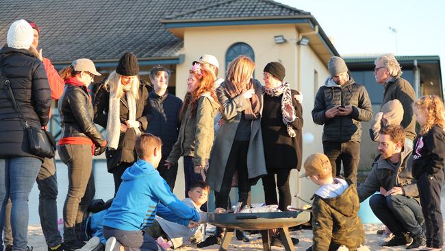 Youngsters toast marshmallows over the fire pit. Picture: John Grainger