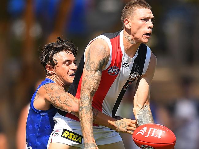 MELBOURNE, AUSTRALIA - MARCH 02: Matt Parker of the Saints handballs whilst being tackled by Marley Williams of the Kangaroos  during the 2019 JLT Community Series AFL match between the North Melbourne Kangaroos and the St Kilda Saints at Avalon Airport Oval on March 02, 2019 in Melbourne, Australia. (Photo by Quinn Rooney/Getty Images)