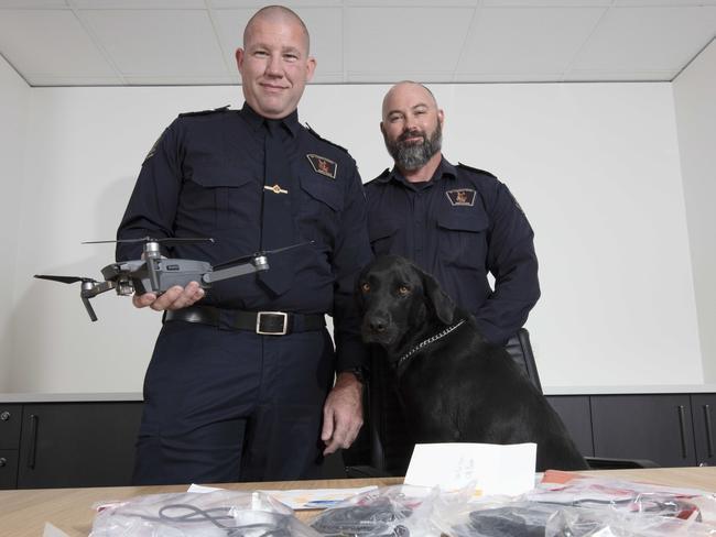 Correctional Services dog handlers Paul Saberton (left) and David Zuromski with evidence gathered from South Australia’s prison system. Picture: Emma Brasier