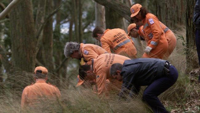 Digital Image. 07/07/1999. SES volunteers and police search the Mount Buninyong scene where the body of Belinda Williams was found. f/l.