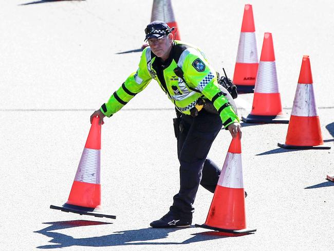 Police set out traffic cones at the Queensland border on the Gold Coast Highway. Picture: Nigel Hallett.