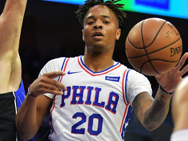 PHILADELPHIA, PA - OCTOBER 20: Markelle Fultz #20 of the Philadelphia 76ers dishes off a pass to teammate Ben Simmons #25 while being defended by Nikola Vucevic #9 of the Orlando Magic at Wells Fargo Center on October 20, 2018 in Philadelphia, Pennsylvania.   Drew Hallowell/Getty Images/AFP == FOR NEWSPAPERS, INTERNET, TELCOS & TELEVISION USE ONLY ==