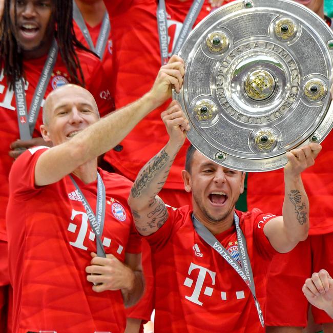 Bayern Munich's Dutch midfielder Arjen Robben and defender Rafinha celebrate with the Bundesliga trophy after a 5-1 win over Eintracht Frankfurt. Picture: John MacDougall/AFP