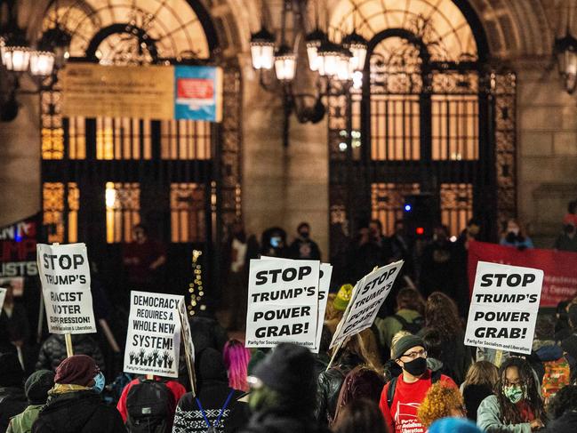 ‘Stop Trum’s power grab’. Joe Biden’s supporters in Boston, Massachusetts. Picture: AFP