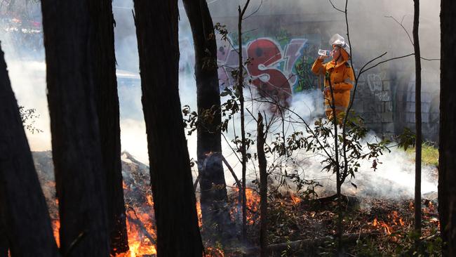 Rural Fire Brigade members perform a hazard reduction burn at Molendinar. Picture Glenn Hampson