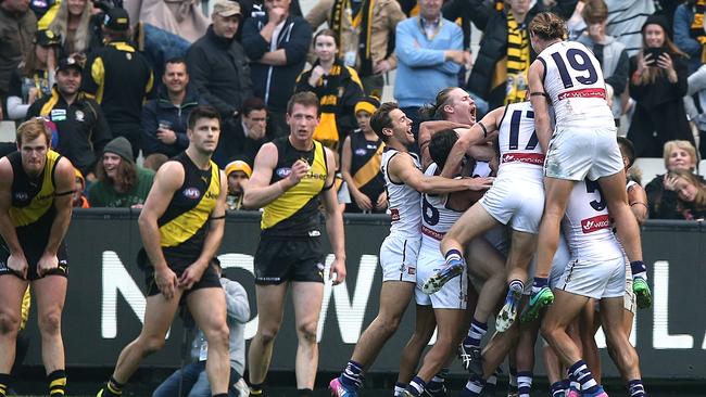 Stunned Richmond players David Astbury, Trent Cotchin and Dylan Grimes as the Dockers celebrate their after-the-siren win. Picture: Wayne Ludbey