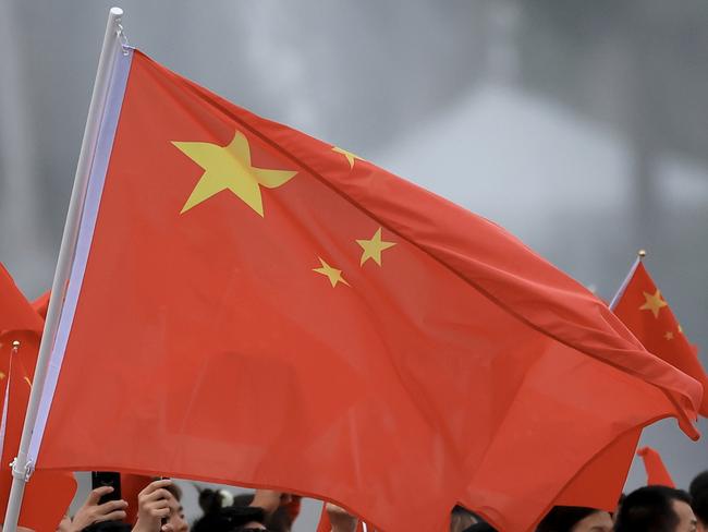 PARIS, FRANCE - JULY 26: Yu Feng and Long Ma, Flagbearers of Team PeopleÃ¢â¬â¢s Republic of China, wave their flag on the team boat along the River Seine during the opening ceremony of the Olympic Games Paris 2024 on July 26, 2024 in Paris, France. (Photo by Maja Hitij/Getty Images)