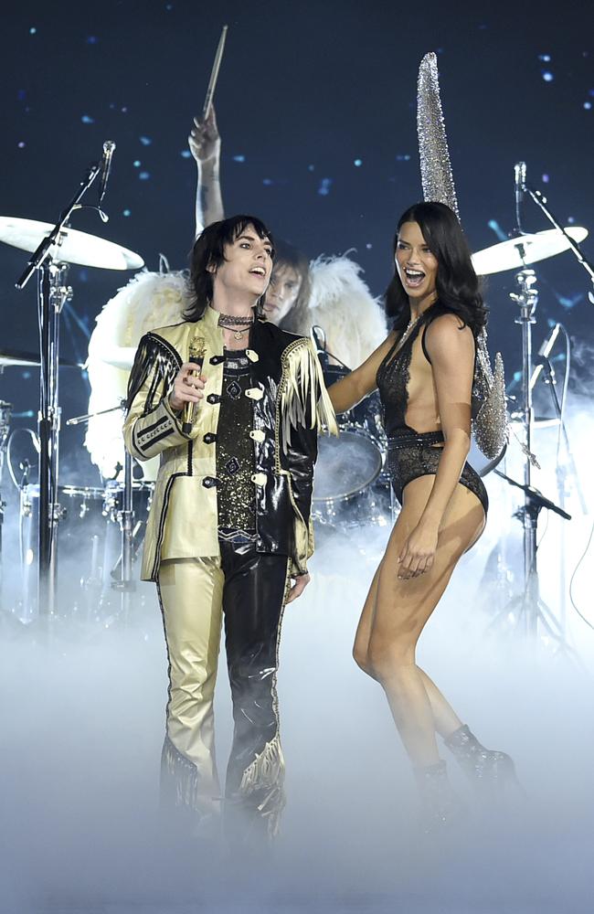 Adriana Lima, right, walks the runway as Luke Spiller of The Struts performs during the 2018 Victoria's Secret Fashion Show at Pier 94 on Thursday, Nov. 8, 2018, in New York. (Photo by Evan Agostini/Invision/AP)