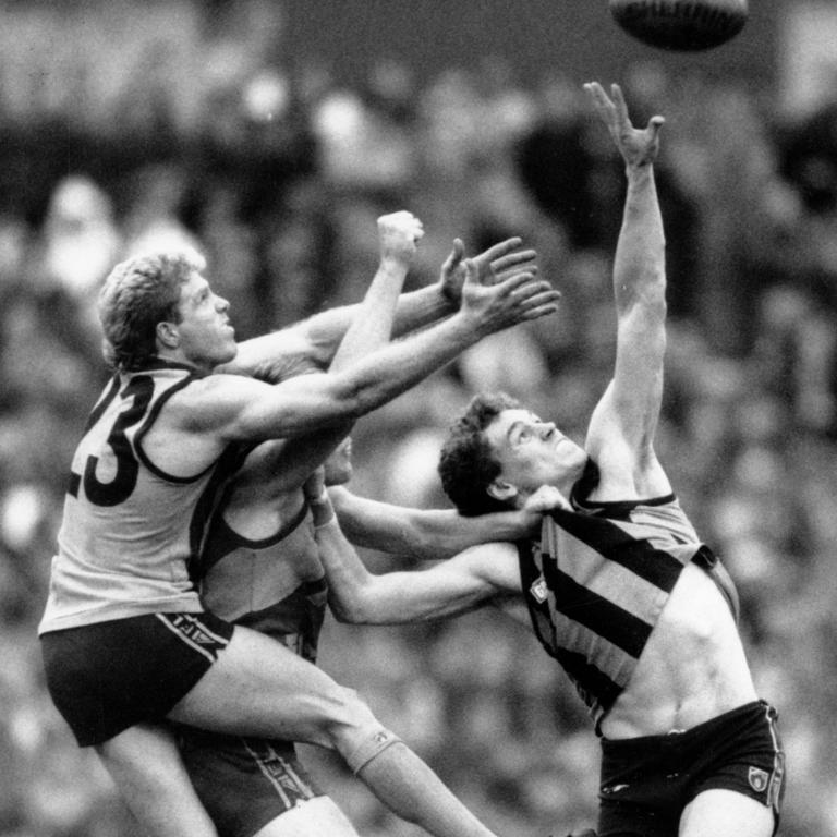 Hawthorn premiership hero Paul Dear (right) flies for a mark with Dermott Brereton in the 1991 grand final between Hawthorn and West Coast. Dear’s son Calsher will debut on Sunday for the Hawks against the Western Bulldogs.