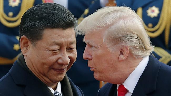 US President Donald Trump, right, chats with Chinese President Xi Jinping during a welcome ceremony at the Great Hall of the People in Beijing last year.