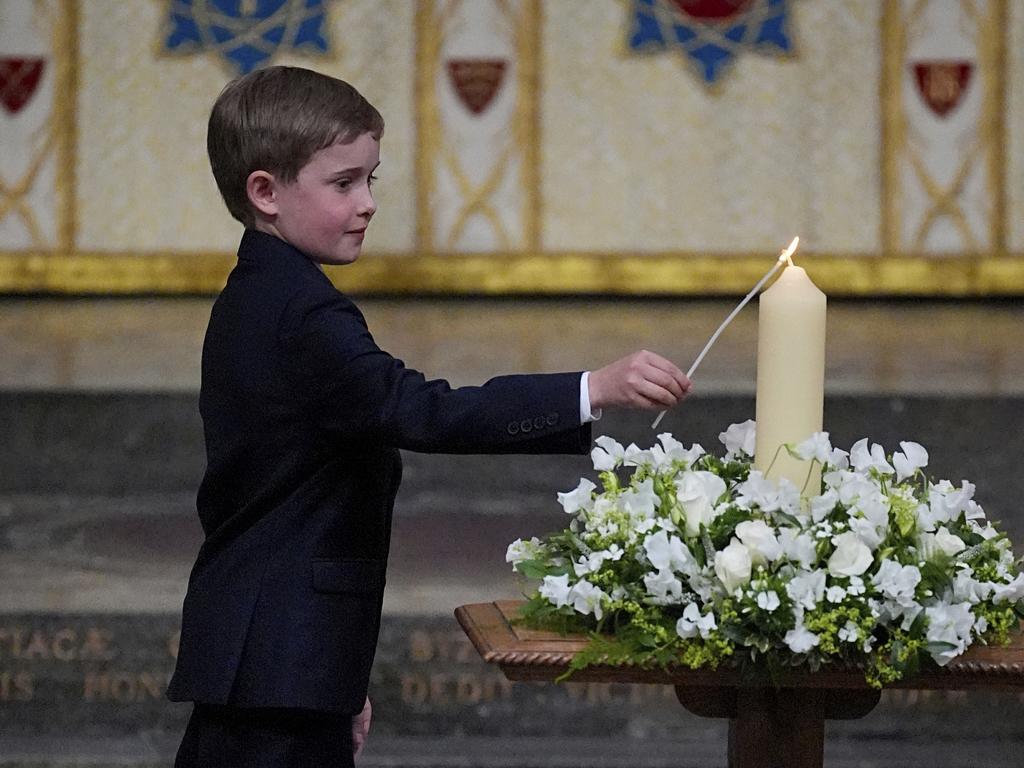 Great-great-grandson of Winston Churchill, Alexander Churchill, 10, lights the V-E Day 80th Candle of Peace during a Service of Thanksgiving at Westminster Abbey in London. Picture: AP Photo
