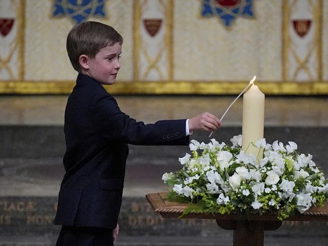 Great-great-grandson of Winston Churchill, Alexander Churchill, 10, lights the V-E Day 80th Candle of Peace during a Service of Thanksgiving at Westminster Abbey in London. Picture: AP Photo