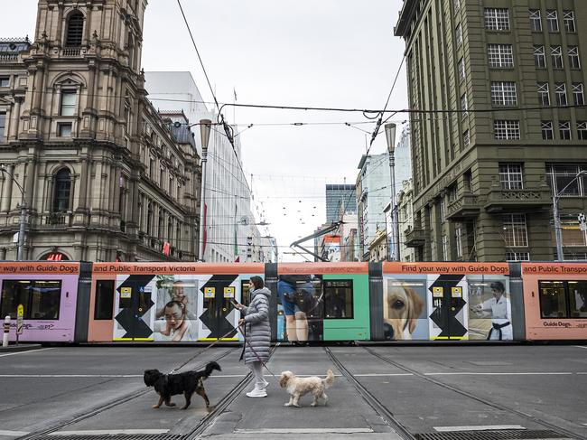 MELBOURNE, AUSTRALIA - JULY 20: A person crosses Bourke Street on July 20, 2021 in Melbourne, Australia. Victoria is under strict lockdown as the state continues to record new community COVID-19 cases and work to stop the spread of the highly infectious delta coronavirus strain in the community. (Photo by Daniel Pockett/Getty Images)