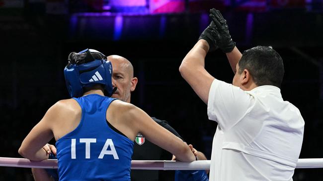 The referee waves off the fight. (Photo by MOHD RASFAN / AFP)