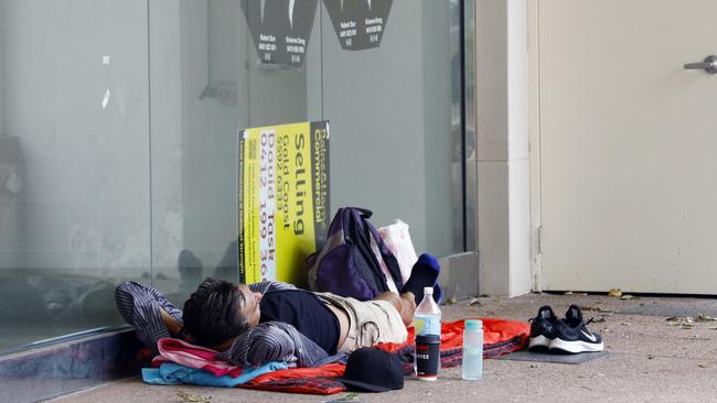 A homeless man sleeps on a street in Surfers Paradise. Picture: Tertius Pickard.