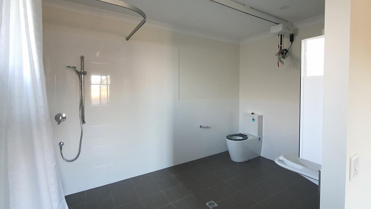 The large toilet and bathroom area fitted out for disability support.