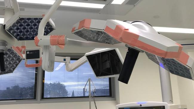 The Labor government says fixing the health system is more of a priority than delivering on the stadium. Lights in an operating theatre at the Launceston General Hospital which have been patched with tape. Picture: Supplied.