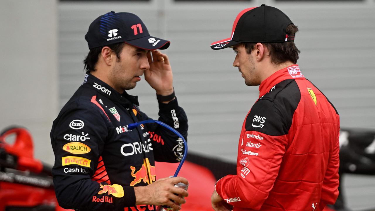 Second placed Red Bull Racing's Mexican driver Sergio Perez (L) speaks with Ferrari's Monegasque driver Charles Leclerc after the Formula One Austrian Grand Prix at the Red Bull racetrack in Spielberg, Austria on July 2, 2023. (Photo by VLADIMIR SIMICEK / AFP)