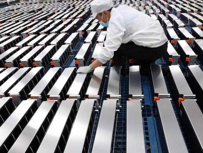 (FILES) This file photo taken on March 12, 2021 shows a worker with car batteries at a factory for Xinwangda Electric Vehicle Battery Co. Ltd, which makes lithium batteries for electric cars and other uses, in Nanjing in China's eastern Jiangsu province. - Lithium, cobalt and nickel, the metals that are essential to the manufacture of the electric batteries that will replace the combustion engines that contribute to global warming, are so sought after that Europe is preparing to open mines and refineries to try to reduce its dependence on imports. (Photo by AFP) / China OUT