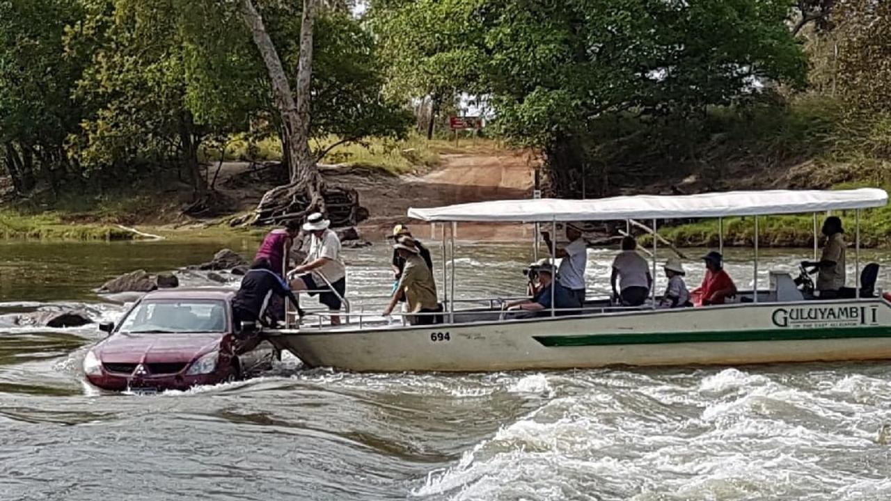 Two people who are rescued from their stranded car after it became stranded on the notoriously croc-infested  Cahills Crossing. Picture: Reijo Keitaanpaa