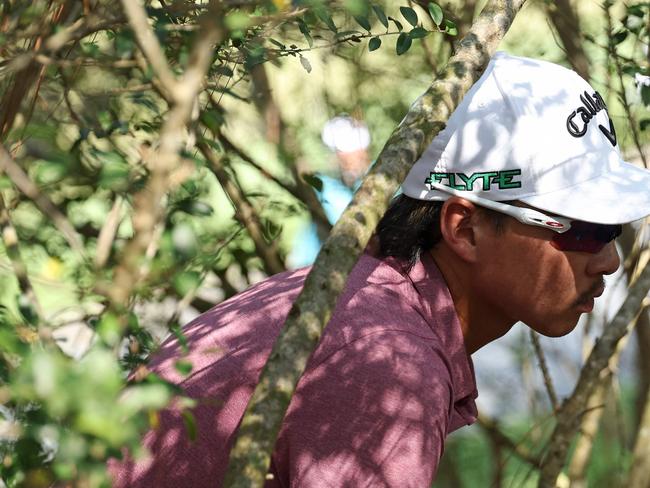 PONTE VEDRA BEACH, FLORIDA - MARCH 15: Min Woo Lee of Australia looks for his ball on the fifth holeduring the third round of THE PLAYERS Championship on the Stadium Course at TPC Sawgrass on March 15, 2025 in Ponte Vedra Beach, Florida.   Logan Bowles/Getty Images/AFP (Photo by Logan Bowles / GETTY IMAGES NORTH AMERICA / Getty Images via AFP)