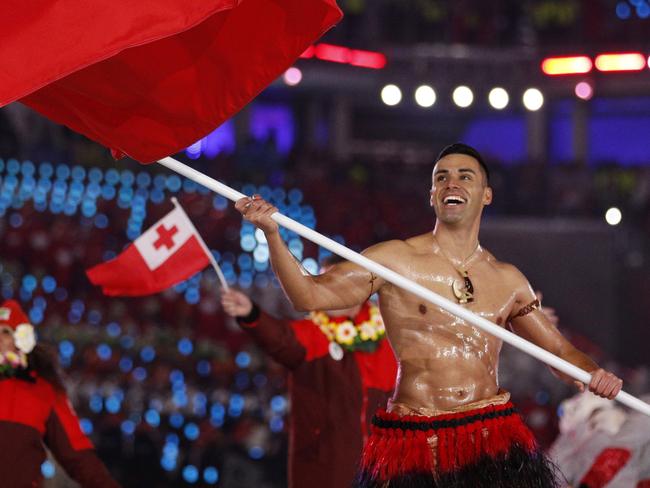 Pita Taufatofua carries the flag of Tonga during the opening ceremony. Picture: AP