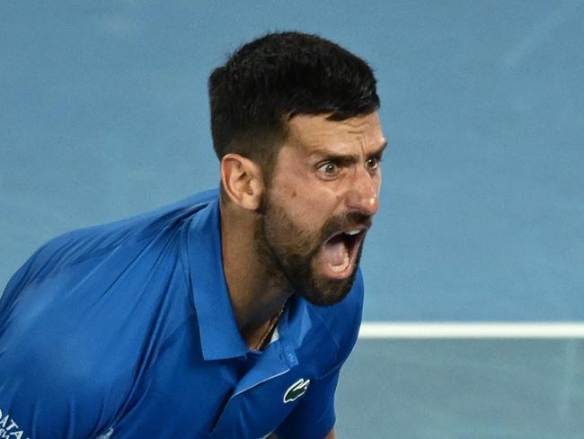 MELBOURNE, AUSTRALIA - JANUARY 21: Novak Djokovic of Serbia celebrates winning match point against Carlos Alcaraz of Spain in the Men's Singles Quarterfinal match during day 10 of the 2025 Australian Open at Melbourne Park on January 21, 2025 in Melbourne, Australia. (Photo by Hannah Peters/Getty Images)