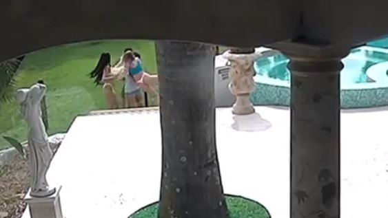 Scantily clad women leap the pool fence at Travers Beynon's 'Candyshop Mansion' to escape a rampaging kangaroo. Picture: Instagram/candyshopmansion
