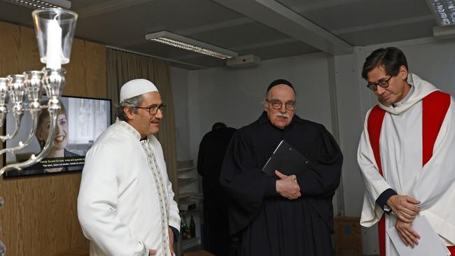 Rabbi Andreas Nachama, Pastor Gregor Hohberg and Imam Kadir Sanci chat ahead of a multi religious prayer to celebrate the beginning of Hanukkah in Berlin. Picture: Getty Images.