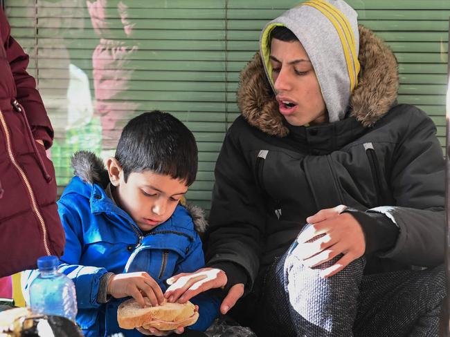 Refugees from Ukraine sit at the railway station in Zahonyi close to the Hungarian Ukrainian border. Picture: AFP