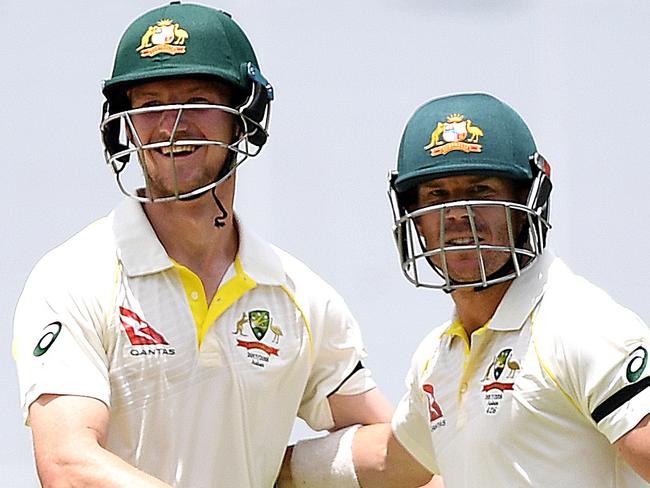 Australian batsmen David Warner (right) and Cameron Bancroft celebrate after Australia won on Day 5 of the First Test match between Australia and England at the Gabba in Brisbane, Monday, November 27, 2017. (AAP Image/Dave Hunt) NO ARCHIVING, EDITORIAL USE ONLY, IMAGES TO BE USED FOR NEWS REPORTING PURPOSES ONLY, NO COMMERCIAL USE WHATSOEVER, NO USE IN BOOKS WITHOUT PRIOR WRITTEN CONSENT FROM AAP