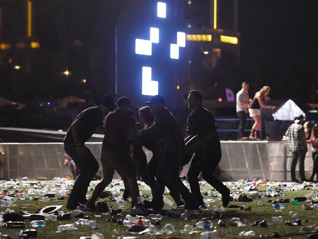 People carry a person at the Route 91 Harvest country music festival. Picture: David Becker/Getty