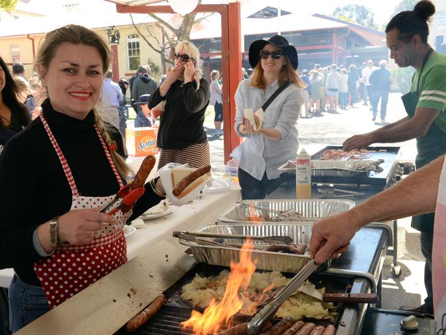Vanessa Baumer-Rowley cooks the sausage sizzle at Neutral Bay Public School during the North Sydney Council Election. Pic: AAP Image/ Jeremy Piper