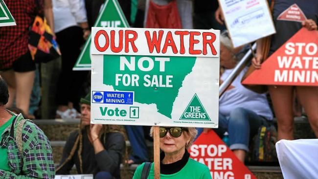 CALL FOR ACTION: One of the many protesters outside the Tweed Shire Council Chambers last week, calling on councillors to stop water extraction. Picture: Scott Powick