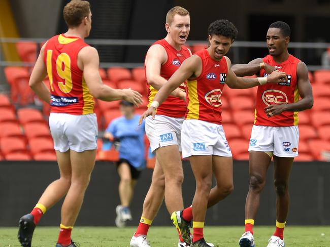 GOLD COAST, AUSTRALIA - FEBRUARY 27: Malcolm Rosas of the Suns celebrates with team mates after kicking a goal during the AFL Practice Match between the Gold Coast Suns and the Brisbane Lions at Metricon Stadium on February 27, 2021 in Gold Coast, Australia. (Photo by Albert Perez/Getty Images via AFL Photos)