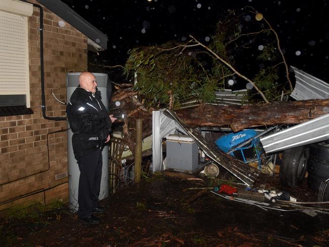 CFS and SES crews at a house in Upper Sturt damaged by a fallen tree this evening. Photo: Naomi Jellicoe