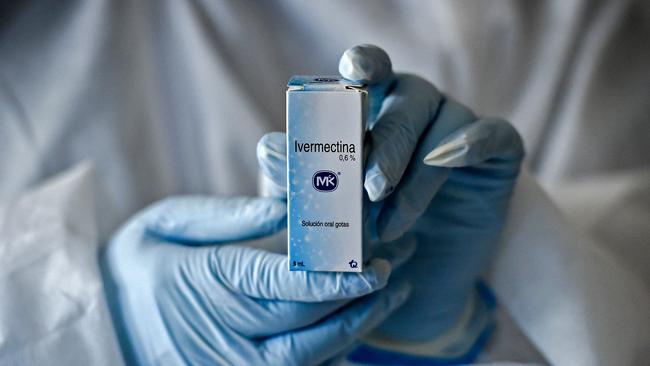 A health worker shows a box containing a bottle of Ivermectin. Picture: AFP