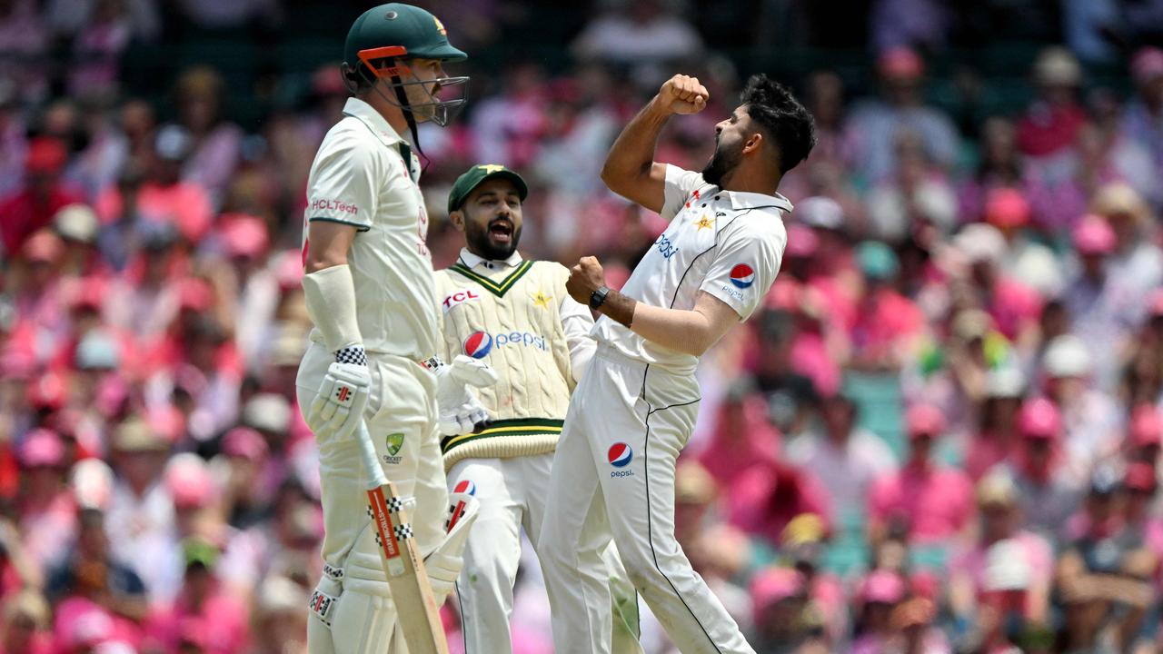 Aamir Jamal (R) celebrates the wicket of Travis Head (L). Picture: Getty