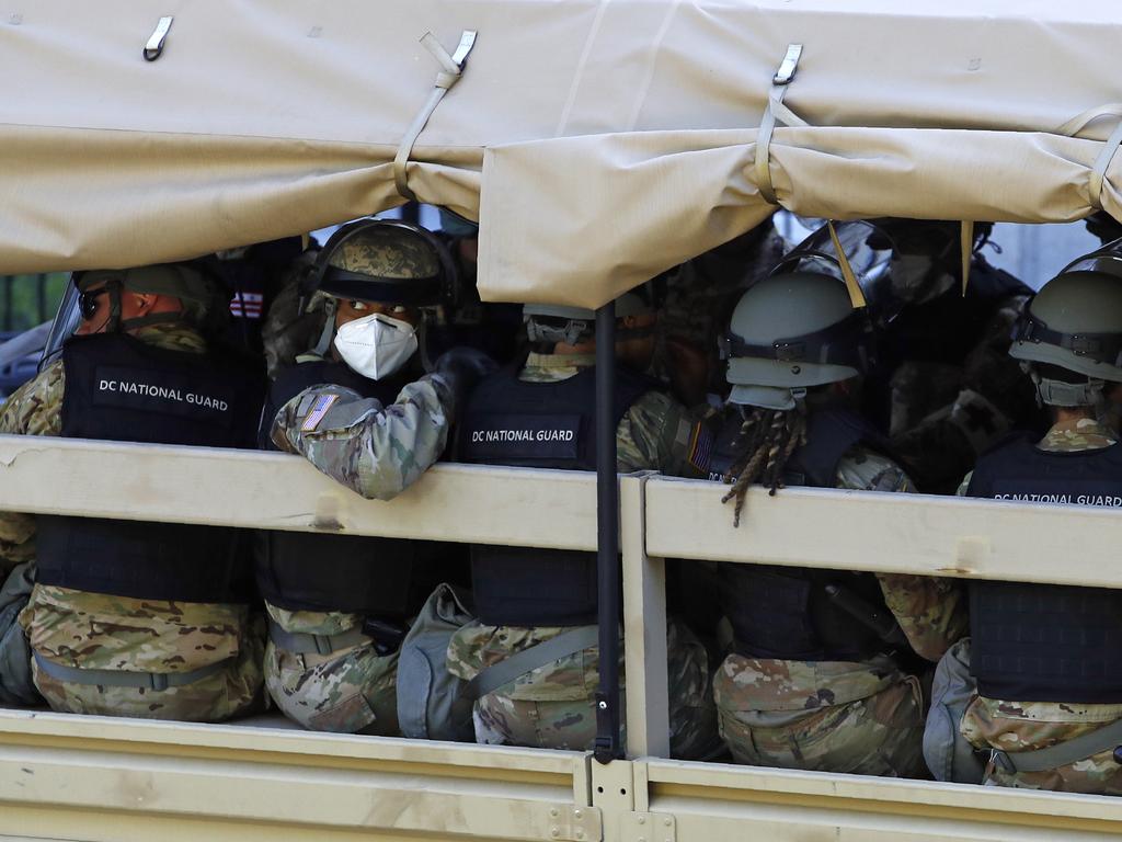 A member of the District of Columbia National Guard looks out from a vehicle driving on West Executive Avenue at the White House. Picture: Patrick Semansky