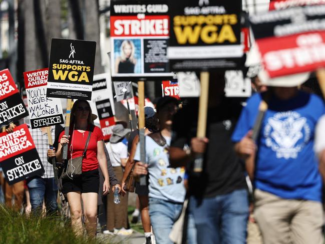 LOS ANGELES, CALIFORNIA - JULY 13: A sign reads 'SAG-AFTRA Supports WGA' as SAG-AFTRA members walk the picket line in solidarity with striking WGA (Writers Guild of America) workers outside Netflix offices on July 13, 2023 in Los Angeles, California. Members of SAG-AFTRA, Hollywoodâs largest union which represents actors and other media professionals, will likely go on strike after a midnight deadline over contract negotiations with studios expired. The strike could shut down Hollywood productions completely with writers in the third month of their strike against Hollywood studios.   Mario Tama/Getty Images/AFP (Photo by MARIO TAMA / GETTY IMAGES NORTH AMERICA / Getty Images via AFP)