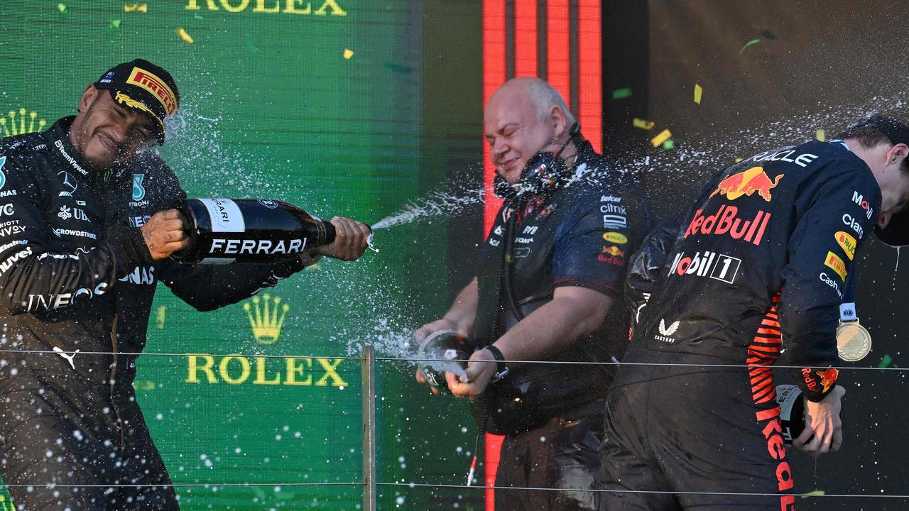 British driver Lewis Hamilton sprays race winner Max Verstappen . Picture: AFP