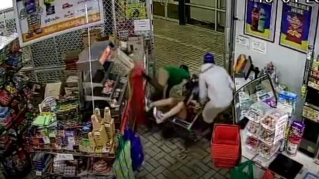 A CCTV still of the incident. The Winnellie Supermarket shop owner is allegedly knocked to the ground by two men as they run from the premises with alcohol. Picture: Supplied