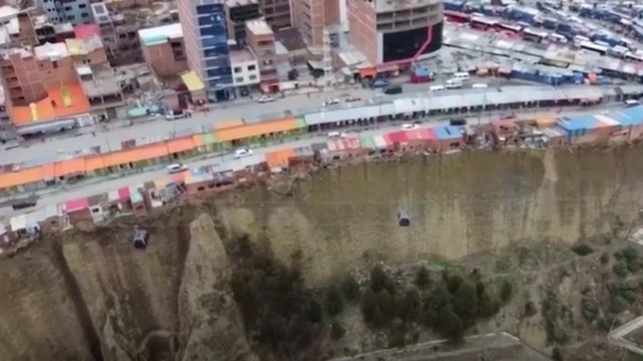 Hanging off the edge of a 60 metre cliff lies a row of flimsy houses that appear to be mere inches away from plunging onto the razor rocks below.