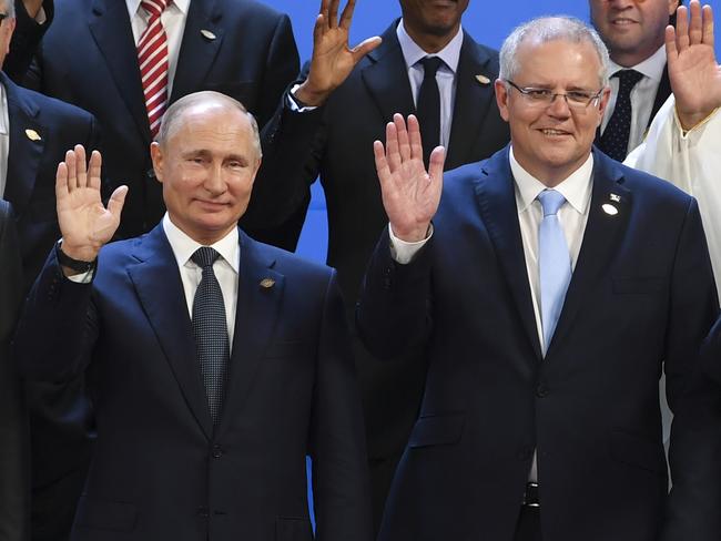 Australian Prime Minister Scott Morrison (centre), President of Russia Vladimir Putin (left), Crown Prince of Saudi Arabia Mohammad Bin Salman Al Saud (top right) and President of Brazil Michel Temer wave during the family picture at the G20 summit in Buenos Aires, Argentina, Friday, November 30, 2018. The leaders of the world's largest economies arrived in Buenos Aires on Thursday for the first G20 summit to be held in South America. (AAP Image/Lukas Coch) NO ARCHIVING